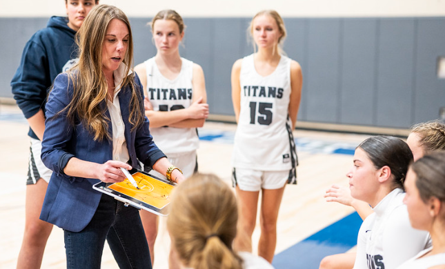 a basketball is going through the net of a basketball hoop .