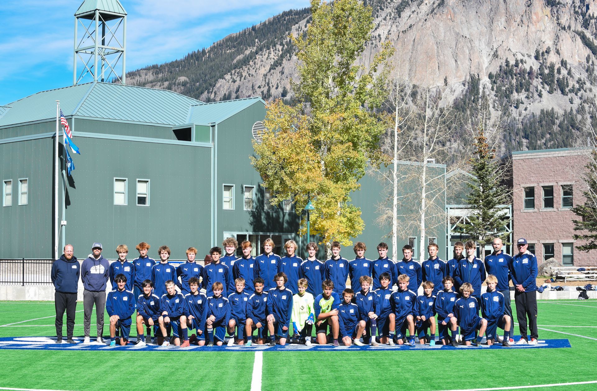 a group of young men are playing soccer on a field .
