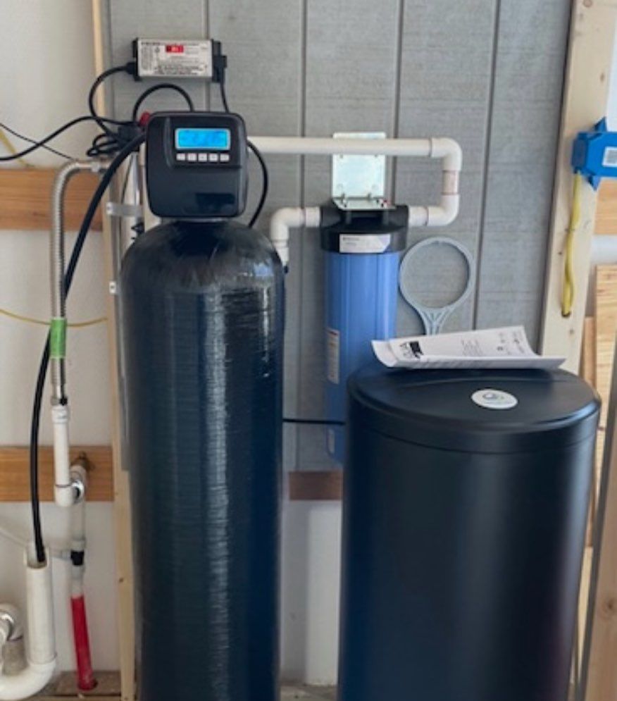 A water treatment system is installed in a garage.