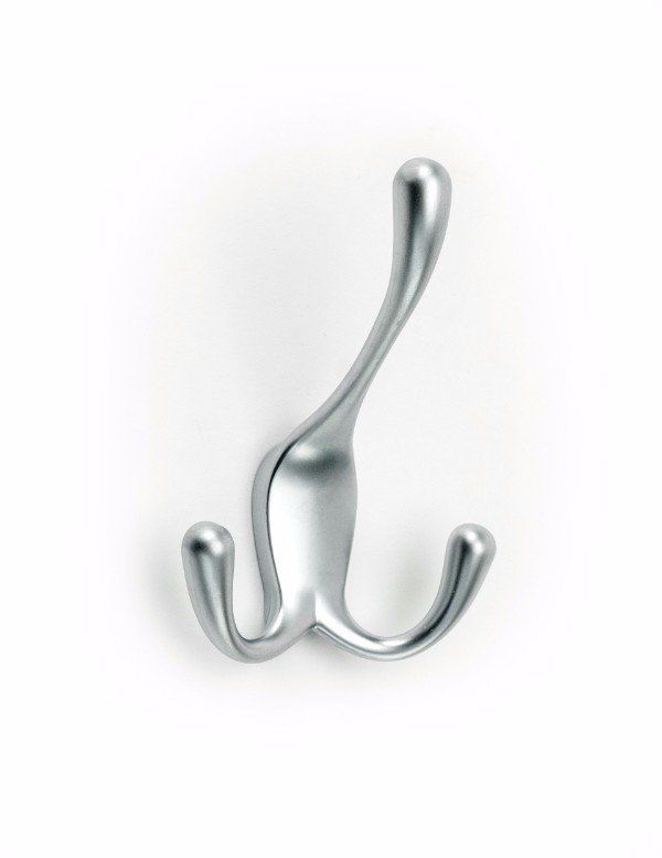 A chrome coat hook is hanging on a white wall.