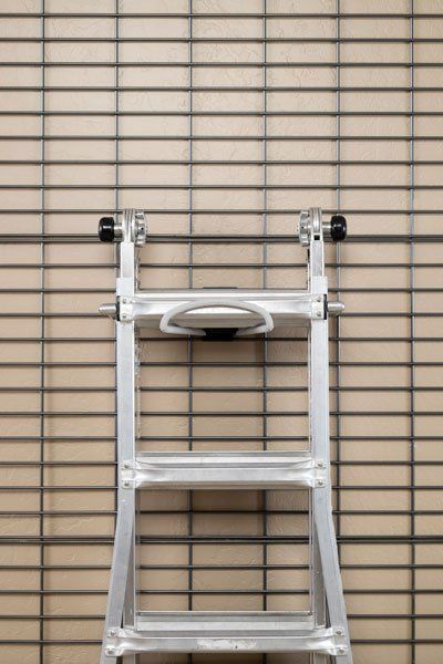 A ladder is leaning against a brick wall.