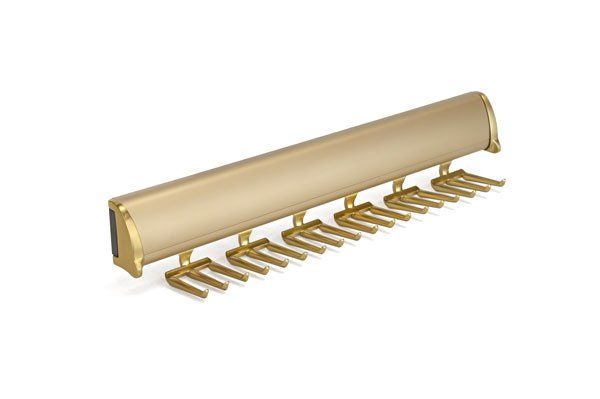 A tie rack with brass hooks on a white background.