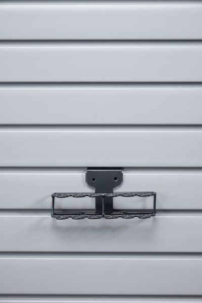 A close up of a tool rack on a wall.