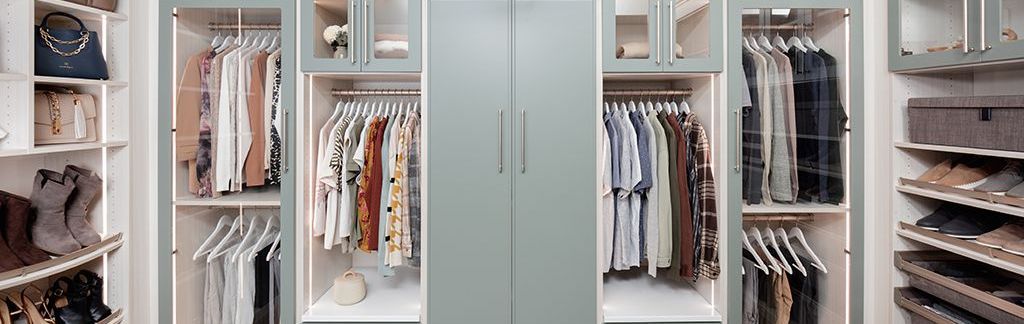 A walk in closet filled with lots of clothes and shoes.