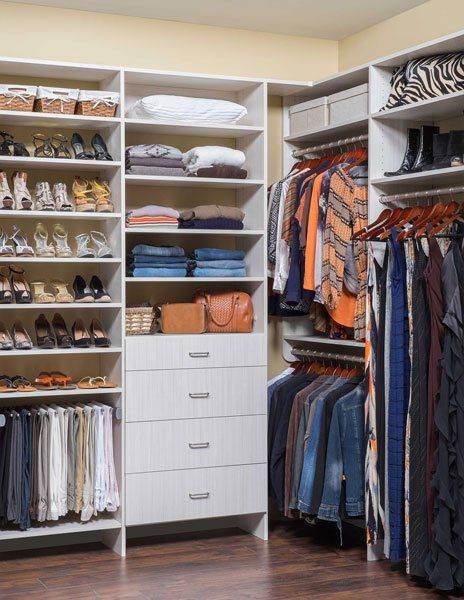 A walk in closet filled with clothes and shoes