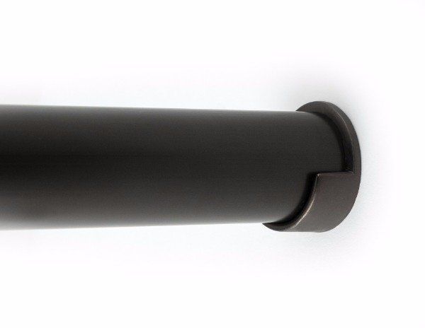 A close up of a black pipe on a white surface.