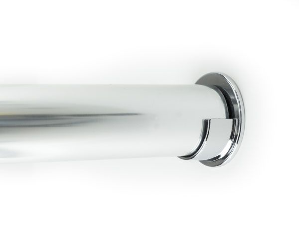 A close up of a chrome shower curtain rod on a white wall.