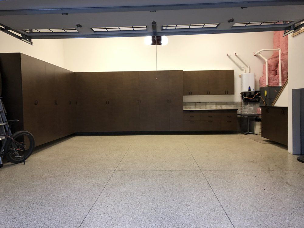 A garage with lots of cabinets and a bicycle in it