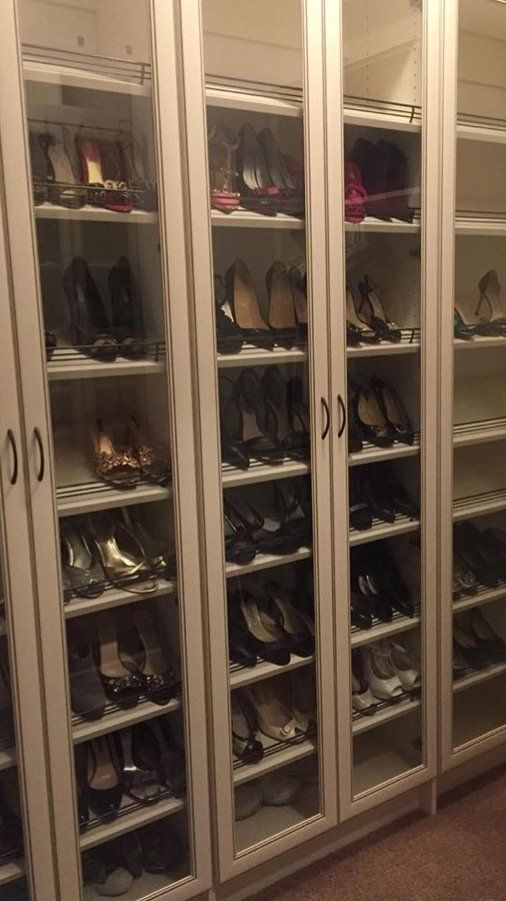 A closet filled with lots of shoes on shelves.