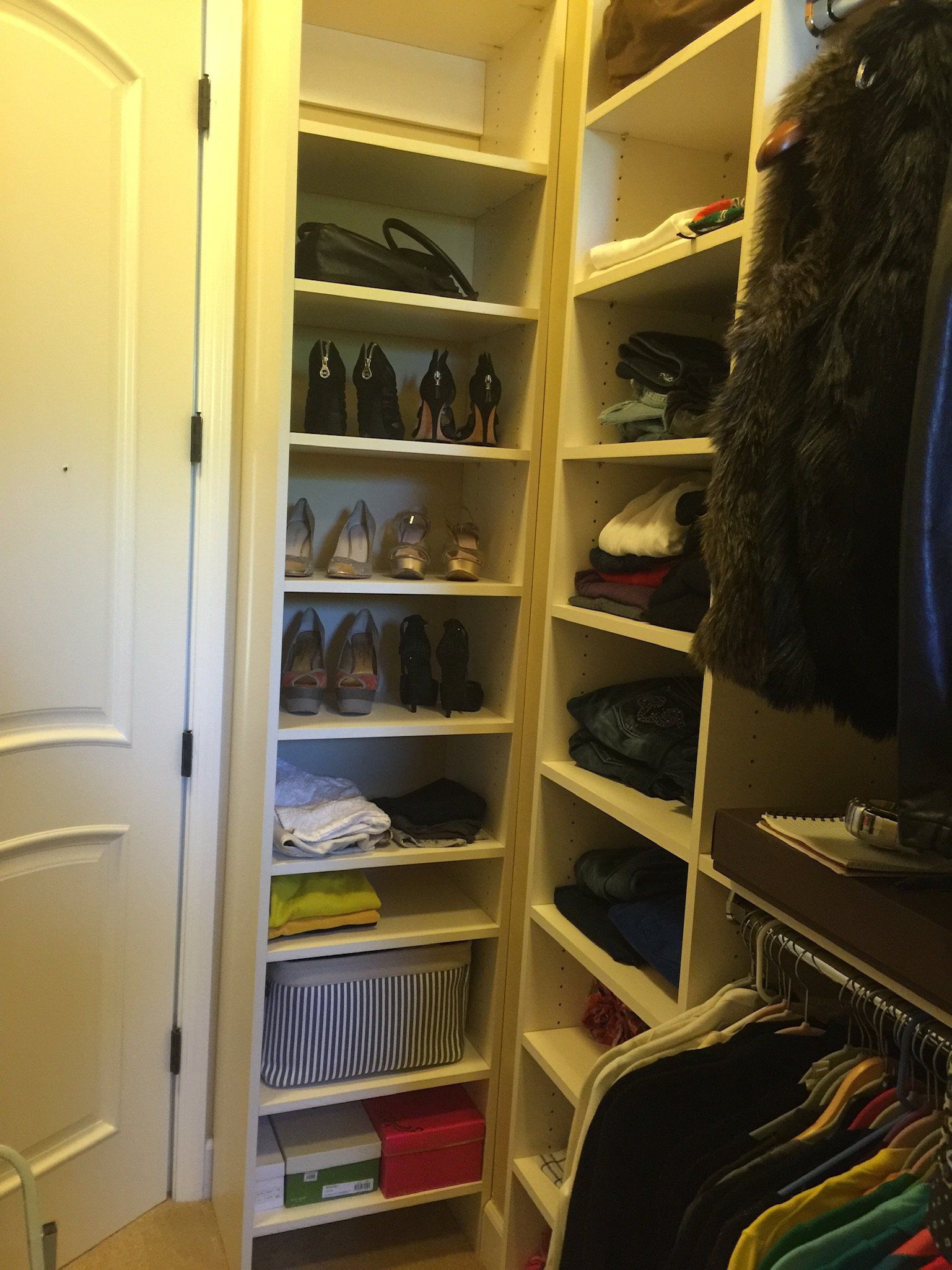 A walk in closet filled with clothes and shoes