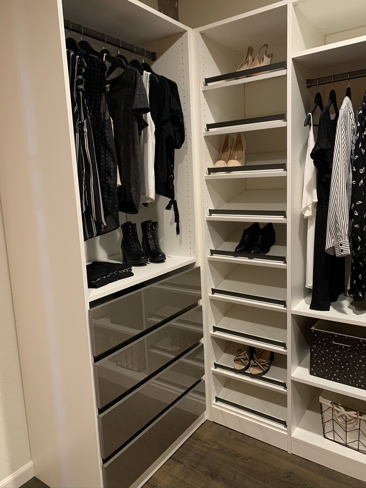 A walk in closet filled with clothes and shoes.