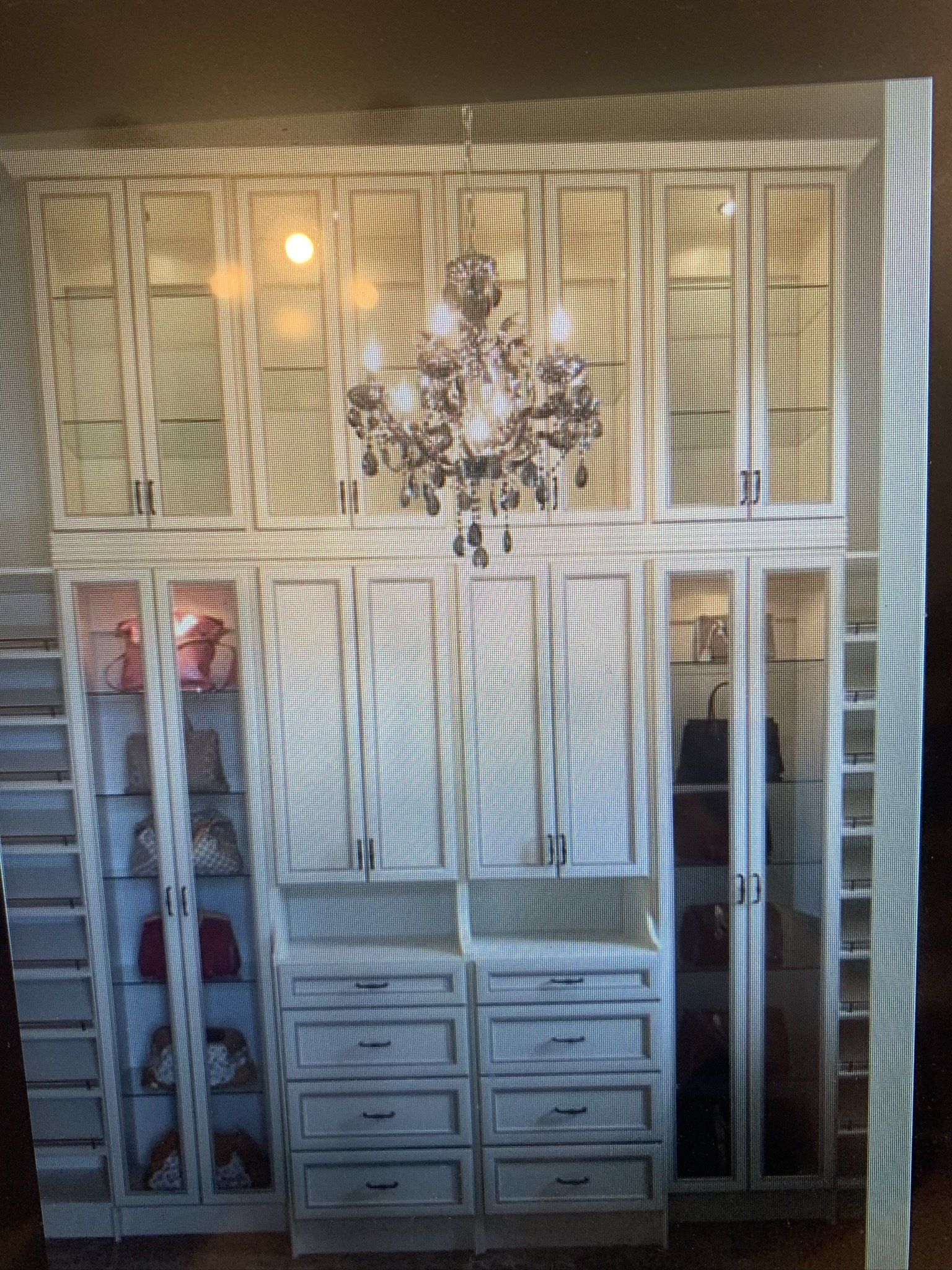 A picture of a closet with a chandelier hanging from the ceiling