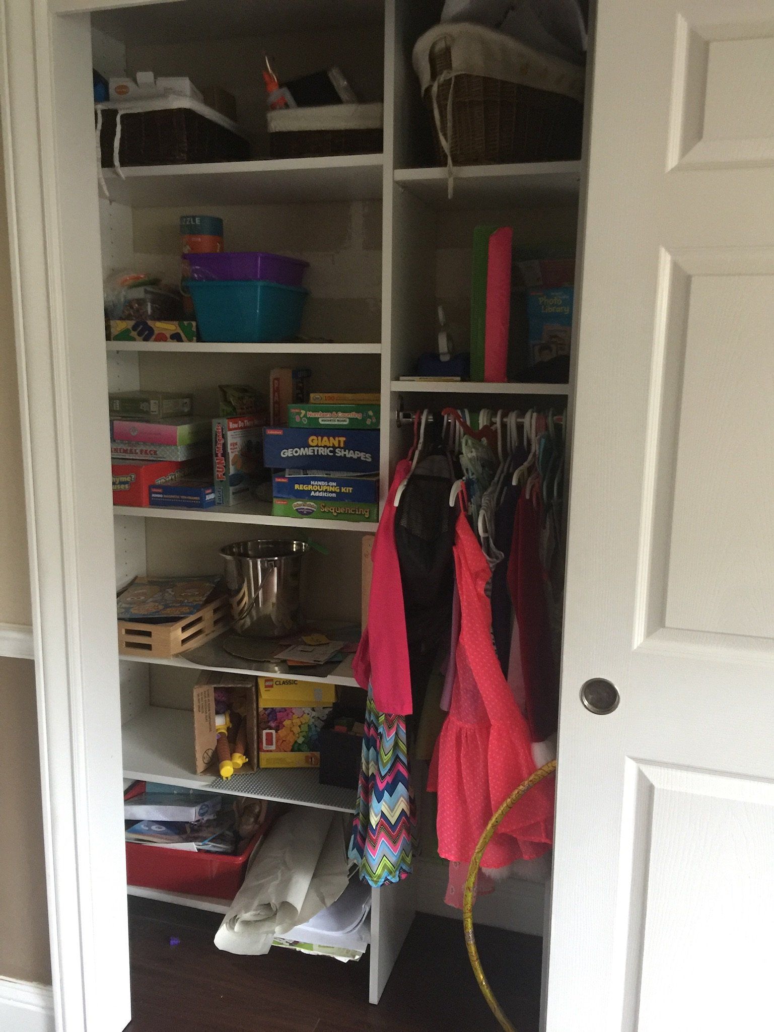 A closet filled with lots of clothes and toys