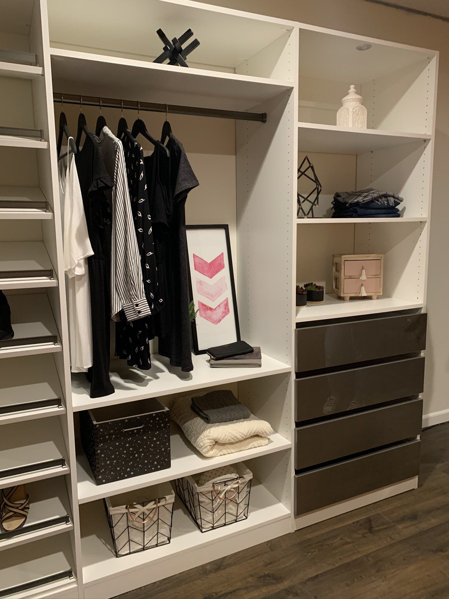 A walk in closet with lots of shelves and drawers filled with clothes.