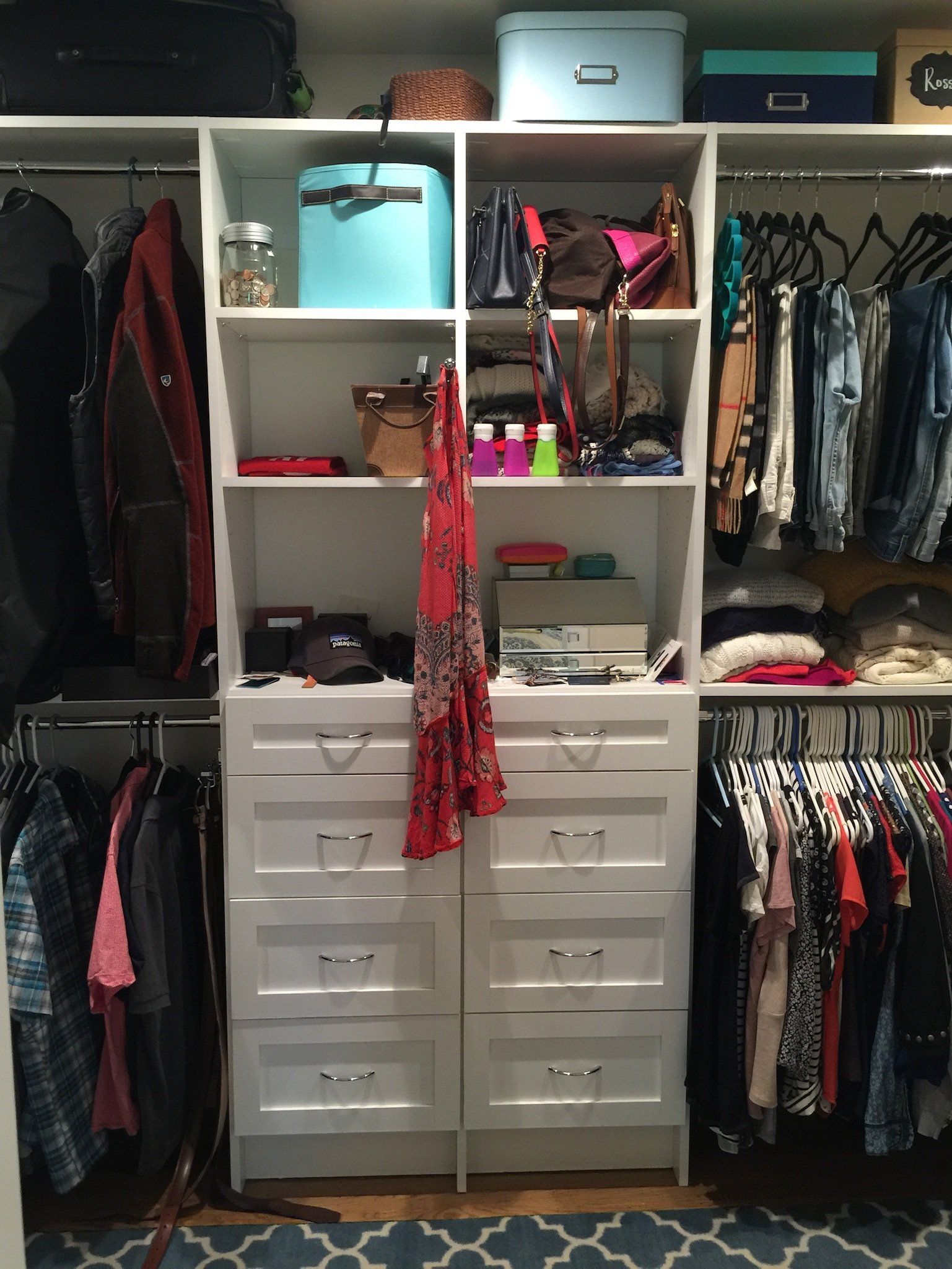 A closet filled with lots of clothes and boxes