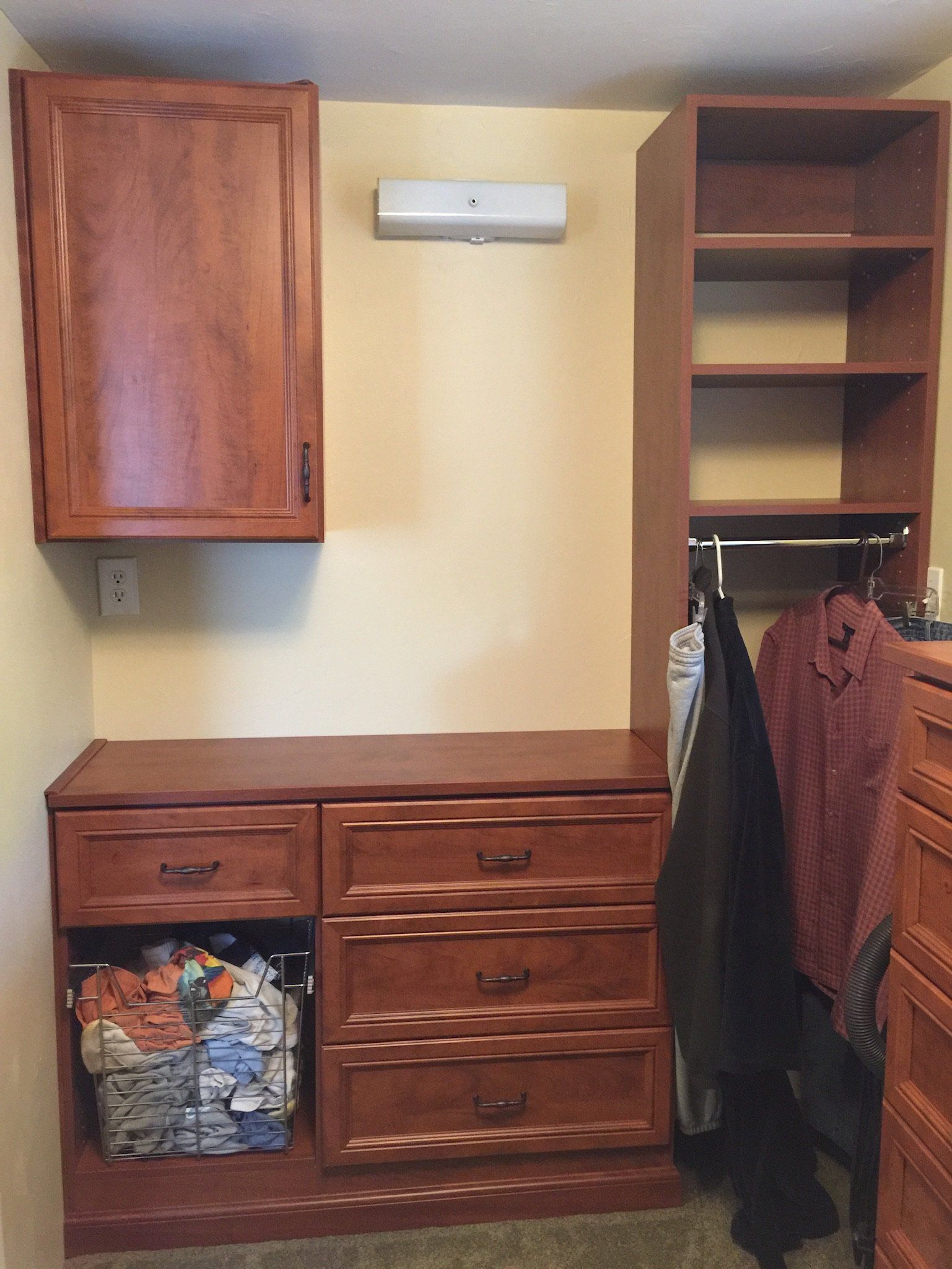 A laundry room with lots of drawers and shelves