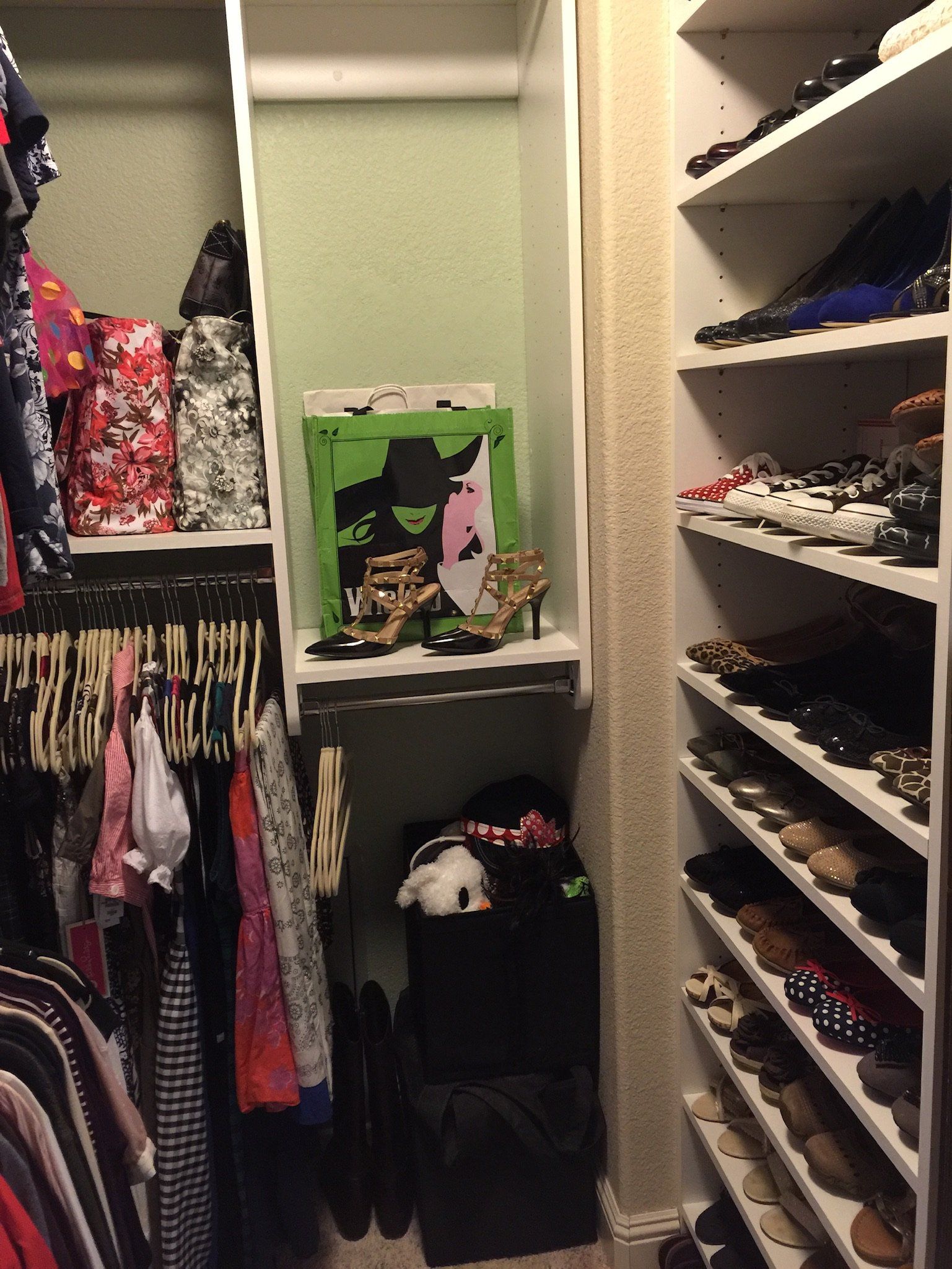 A closet filled with lots of clothes and shoes.