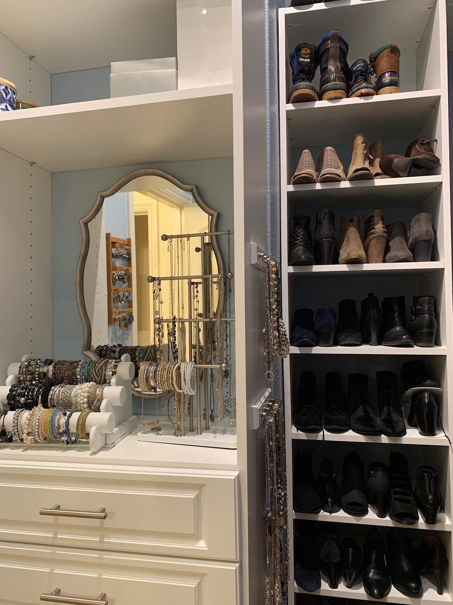 A closet filled with lots of jewelry and shoes.