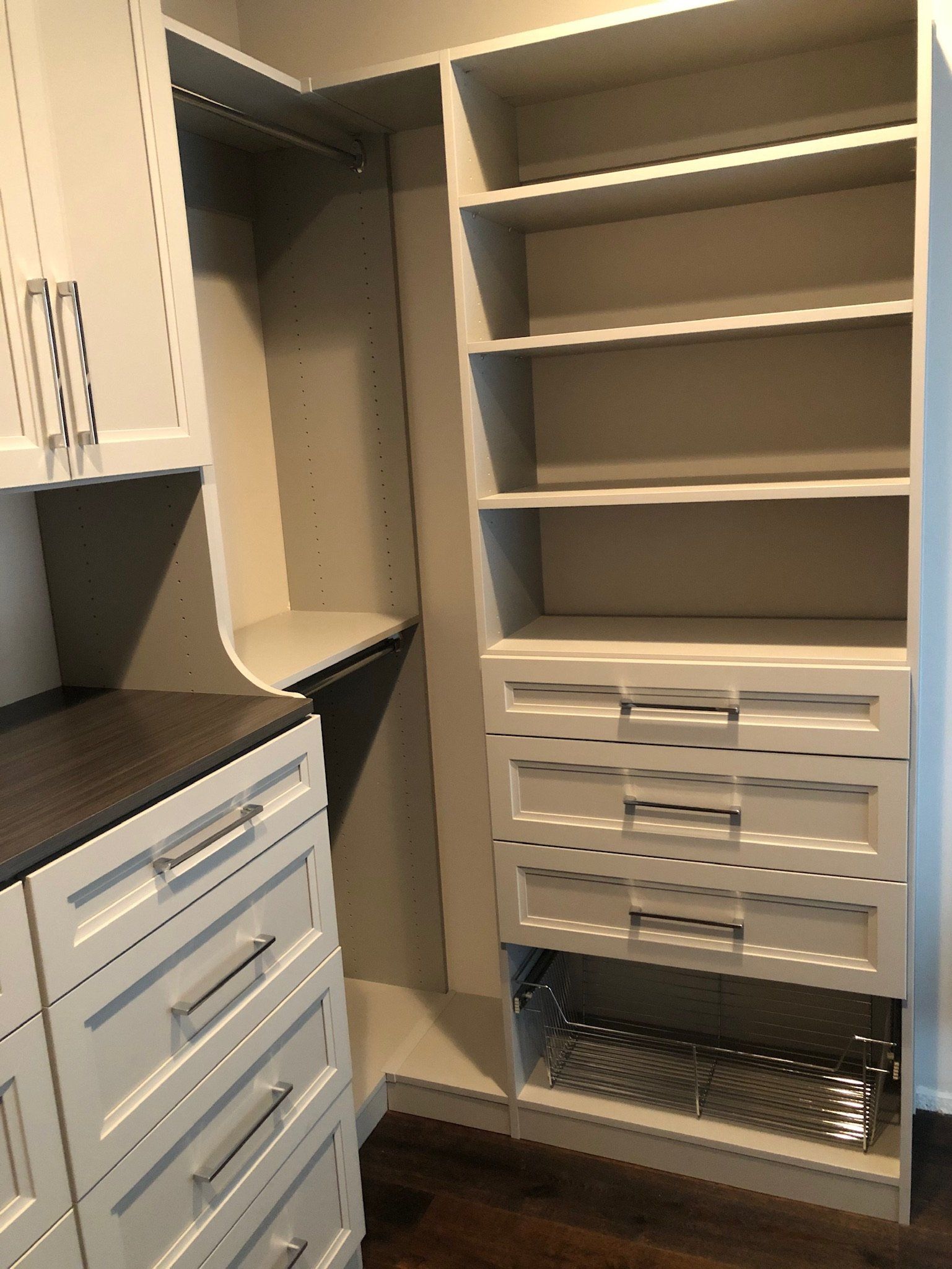 A walk in closet with lots of shelves and drawers