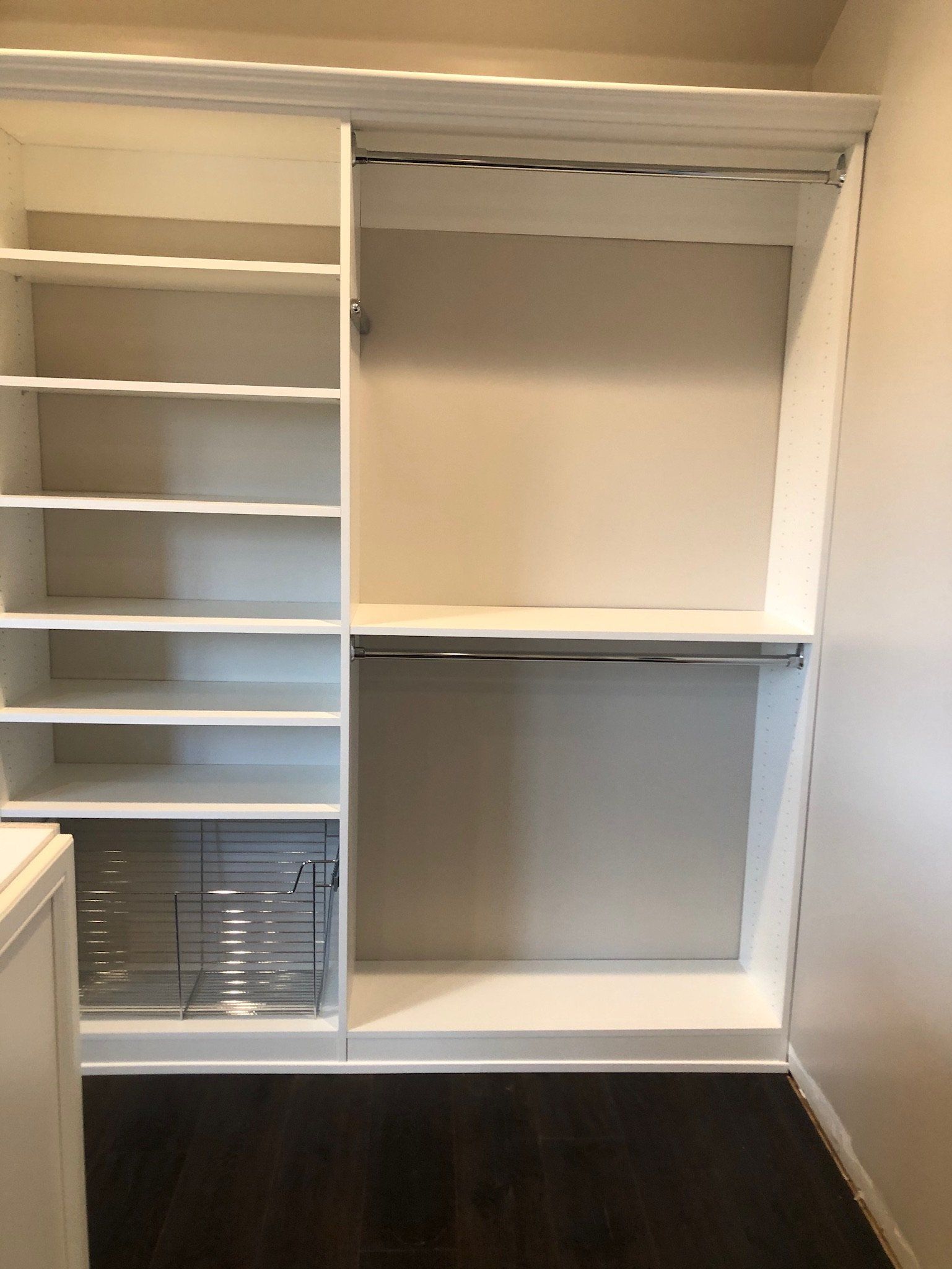 An empty walk in closet with shelves and drawers