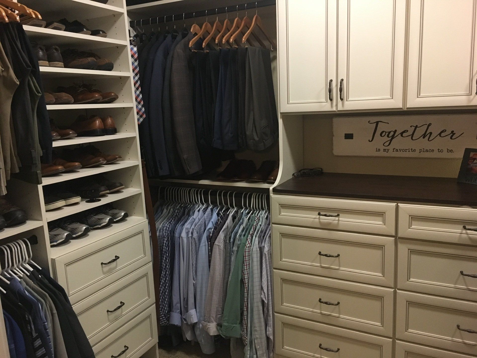 A walk in closet with a sign that says together