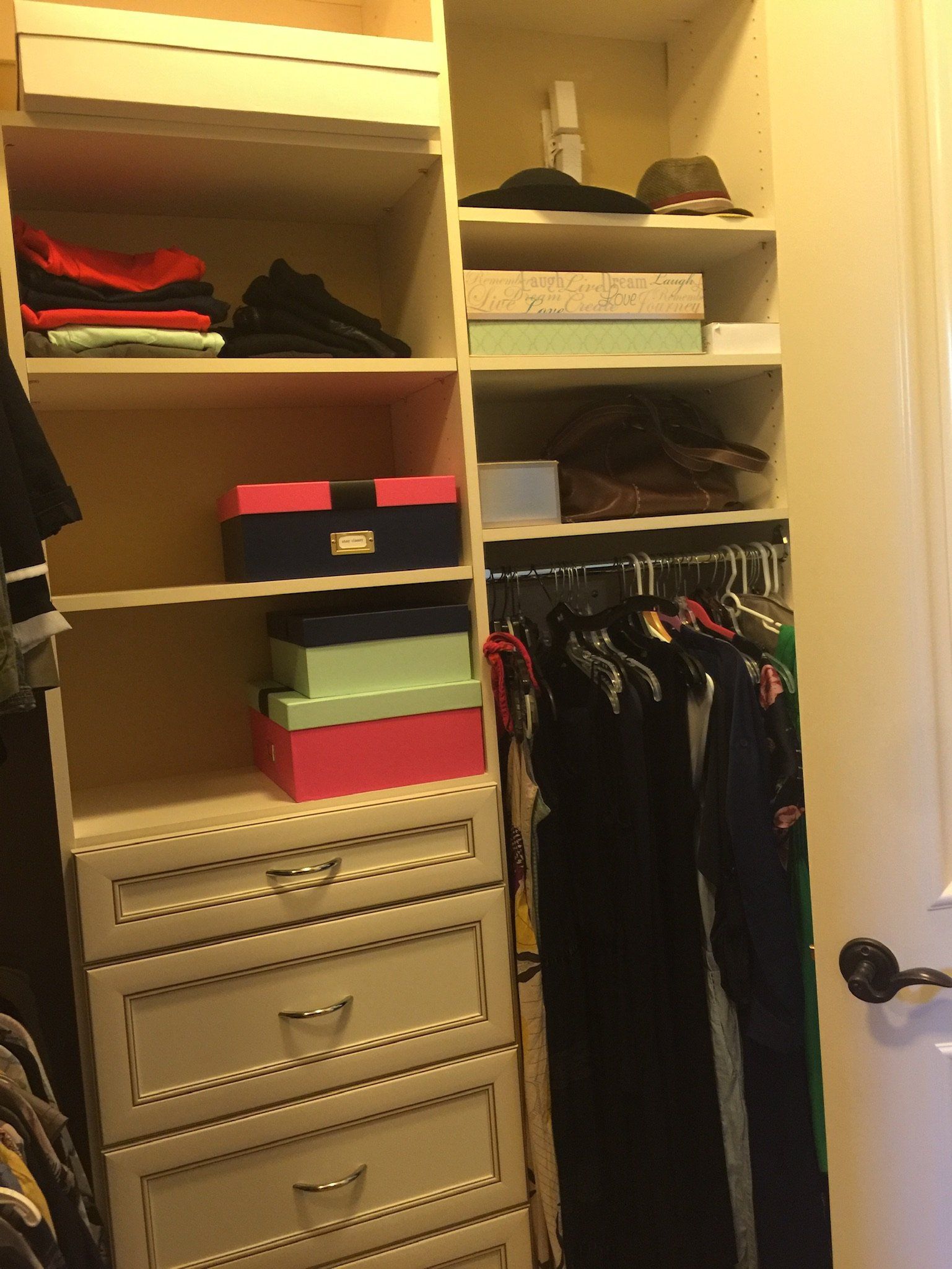 A closet filled with lots of clothes and boxes