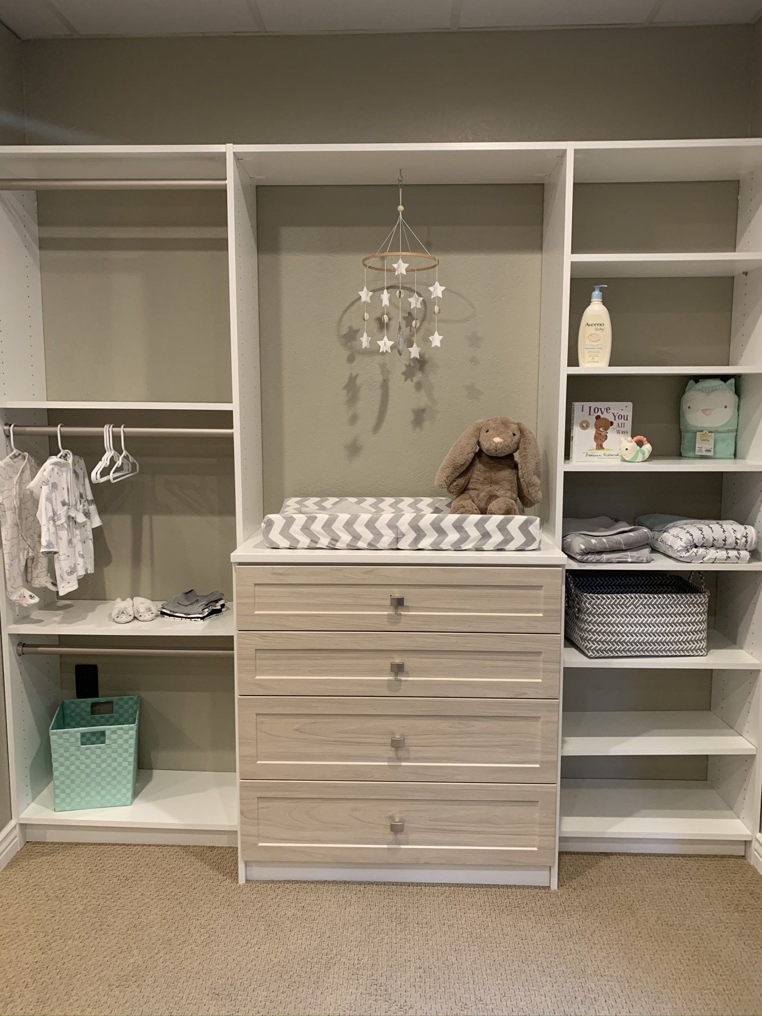 There is a changing table in the middle of the closet.
