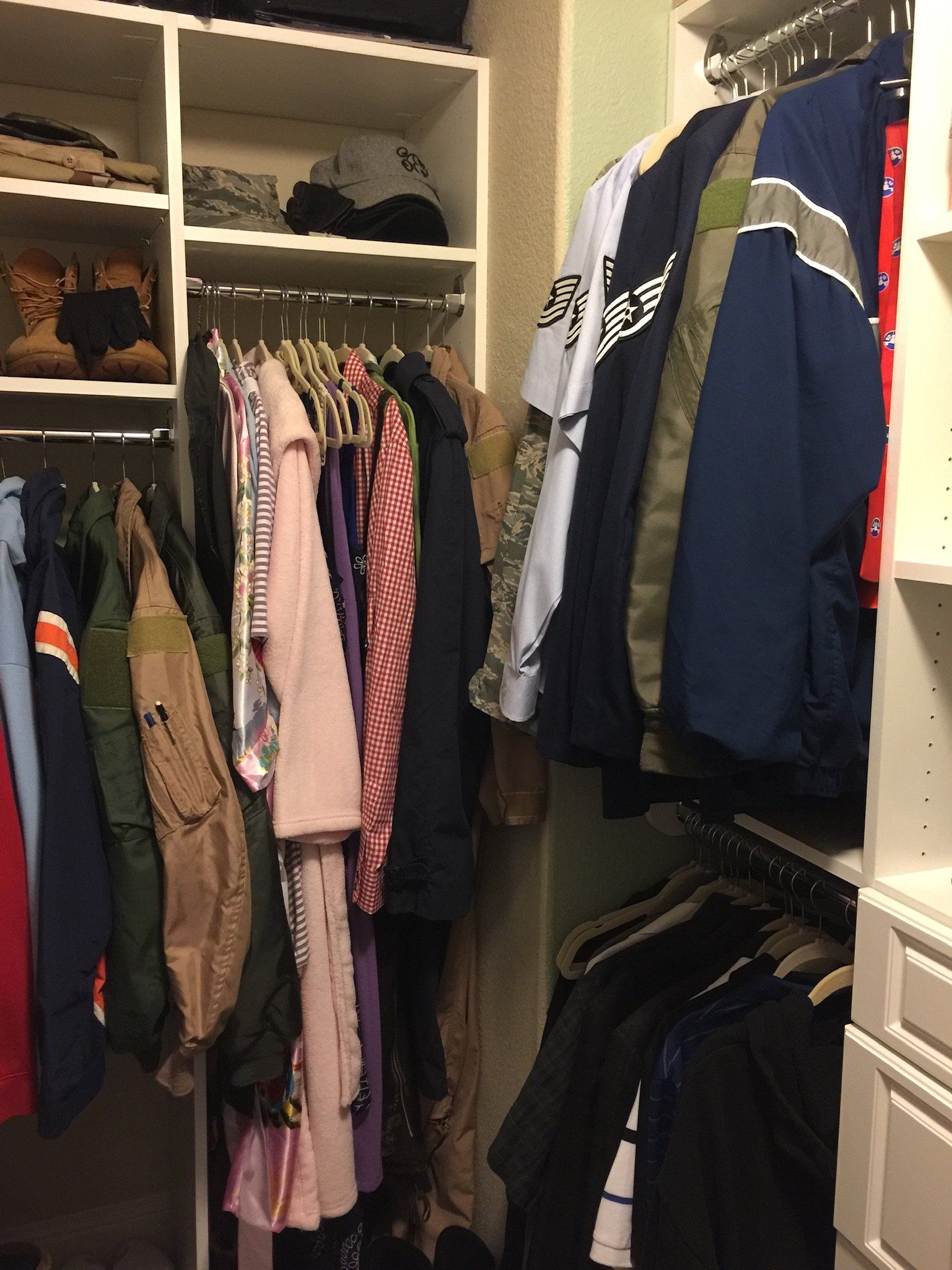 A closet filled with lots of clothes including a jacket that says ' supreme ' on it
