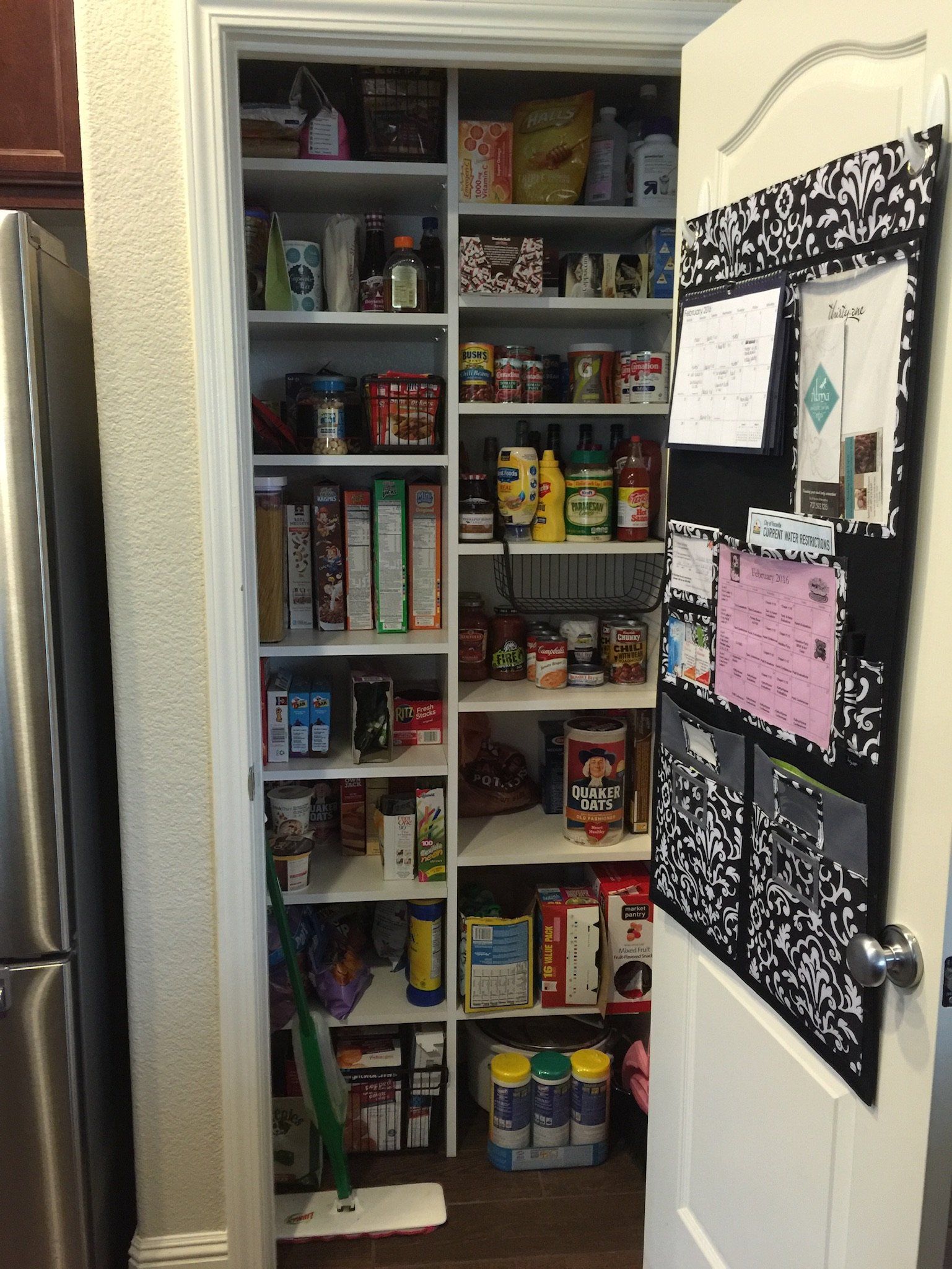 A pantry in a kitchen with a chalkboard on the wall