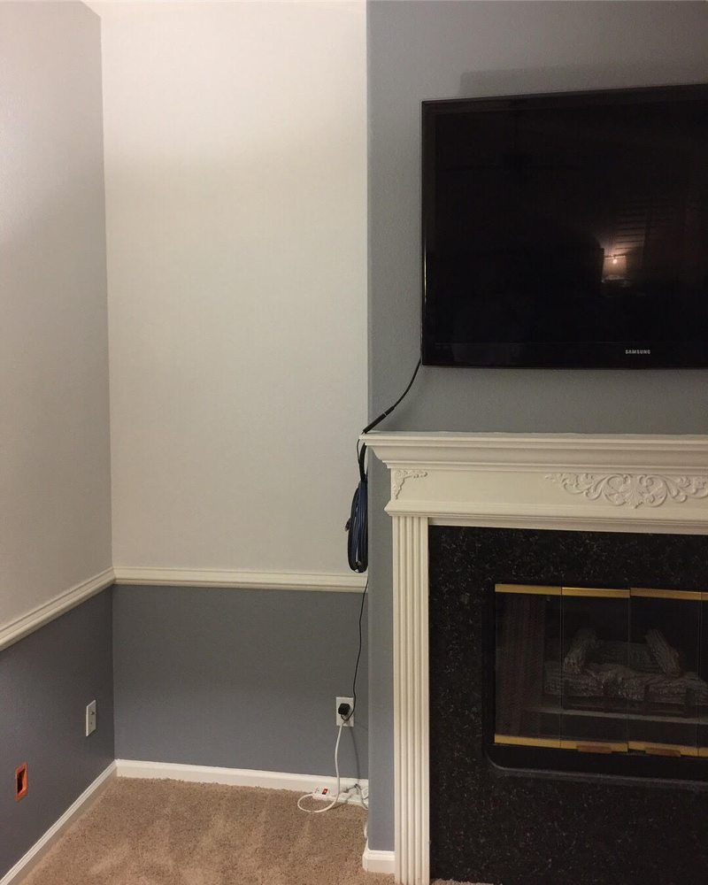 A living room with a fireplace and a flat screen tv