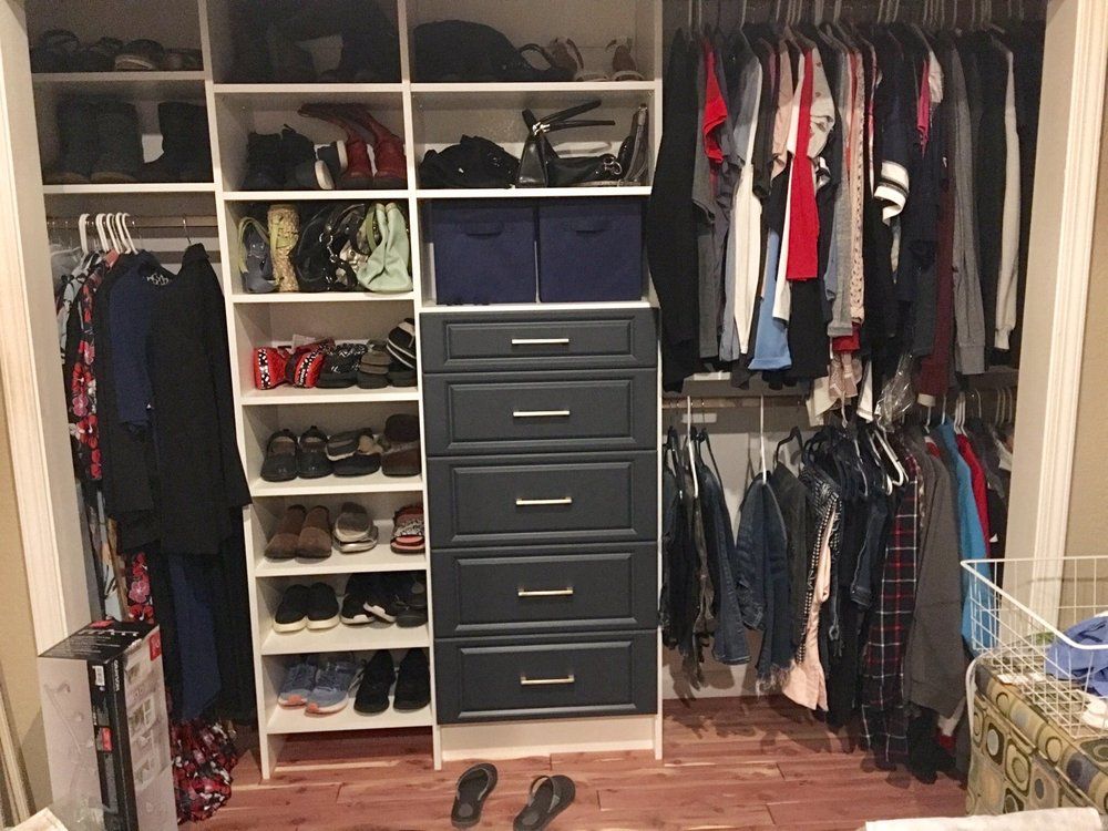 A closet filled with lots of clothes and shoes.