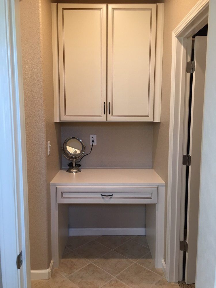 There is a small desk with a mirror on it.