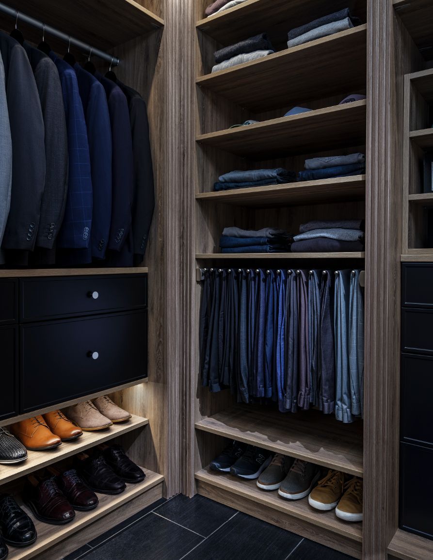A walk in closet filled with lots of clothes and shoes.