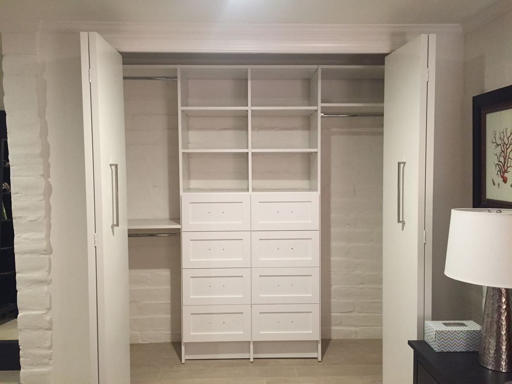 A closet with a lamp and a picture on the wall