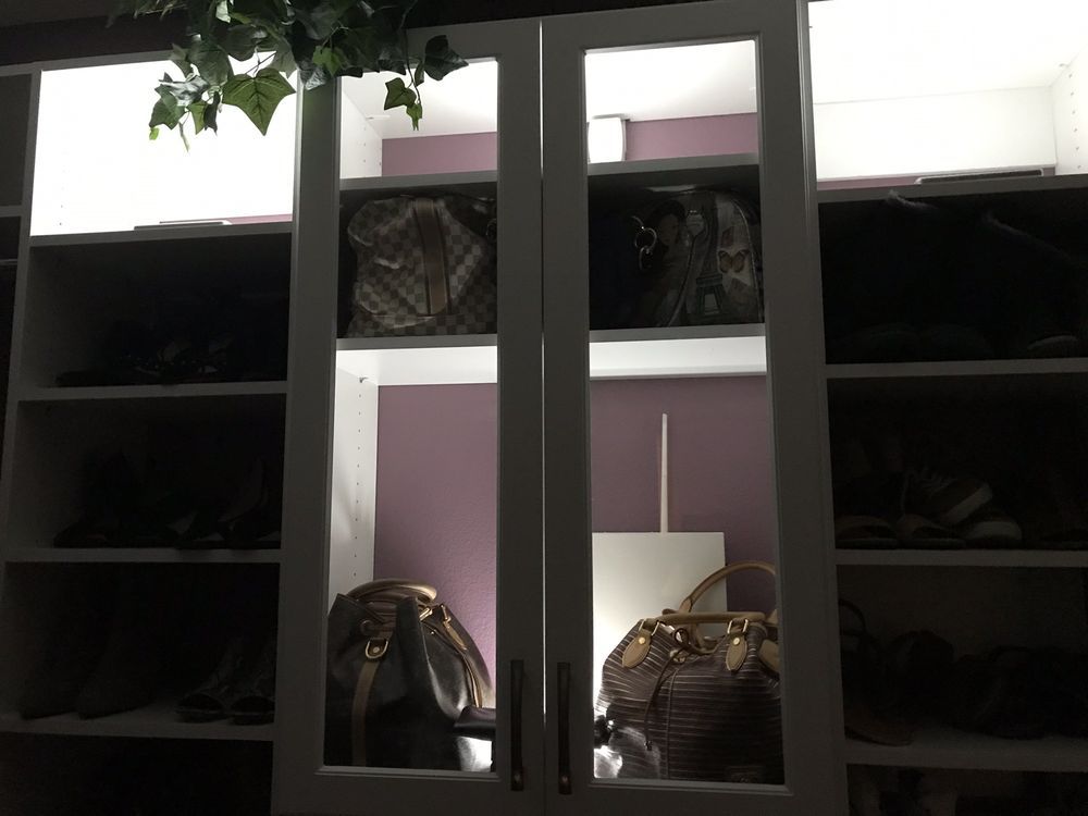 A closet filled with lots of bags and shoes