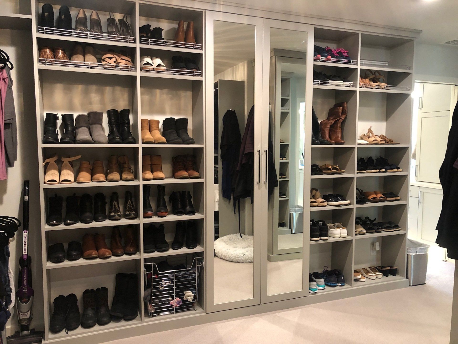 A closet filled with lots of shoes and clothes
