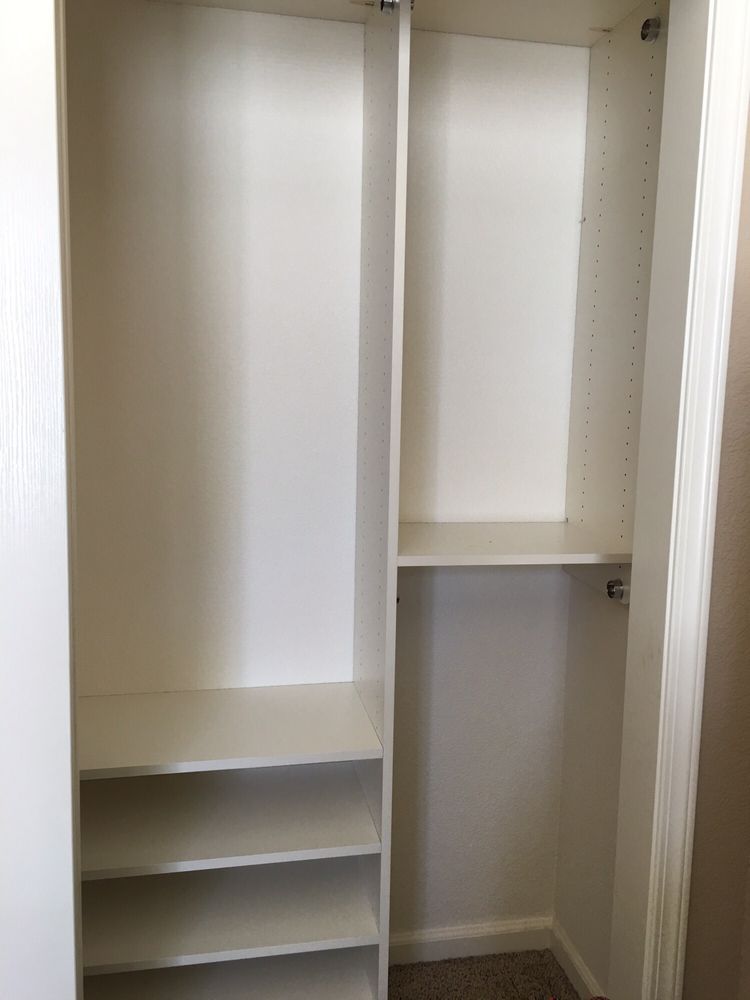 An empty closet with shelves and a door