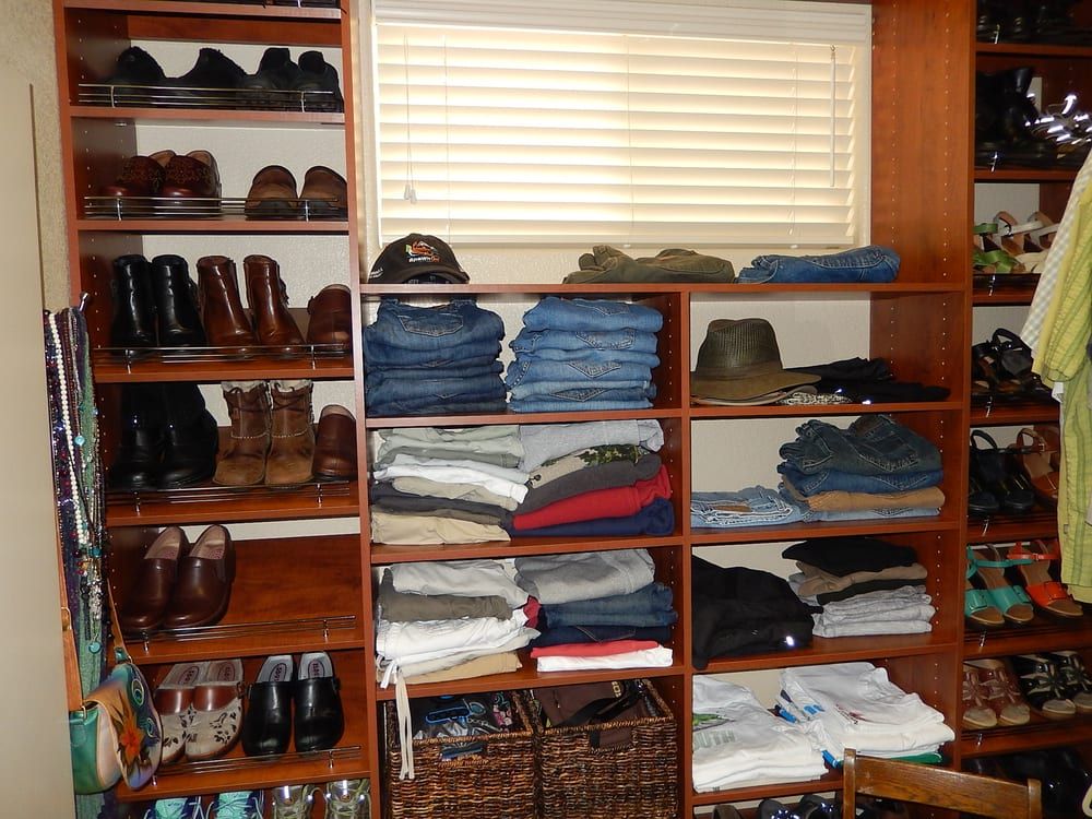A closet filled with lots of clothes and shoes