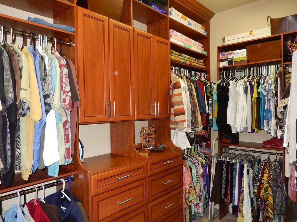A walk in closet filled with lots of clothes and drawers
