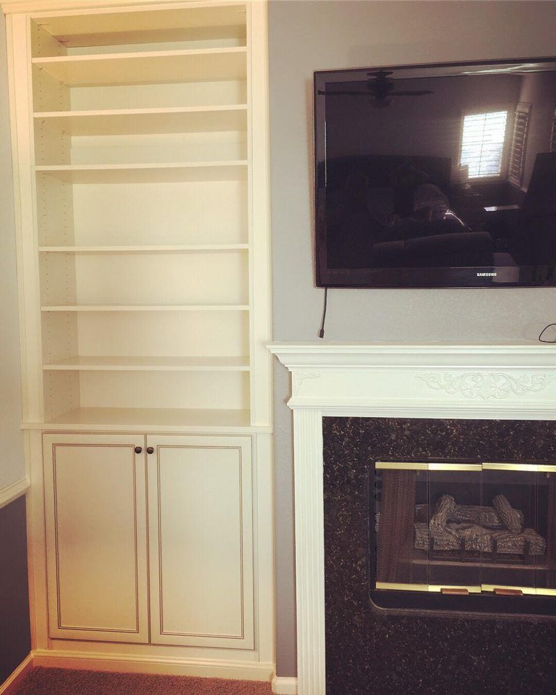 A living room with a fireplace and a flat screen tv