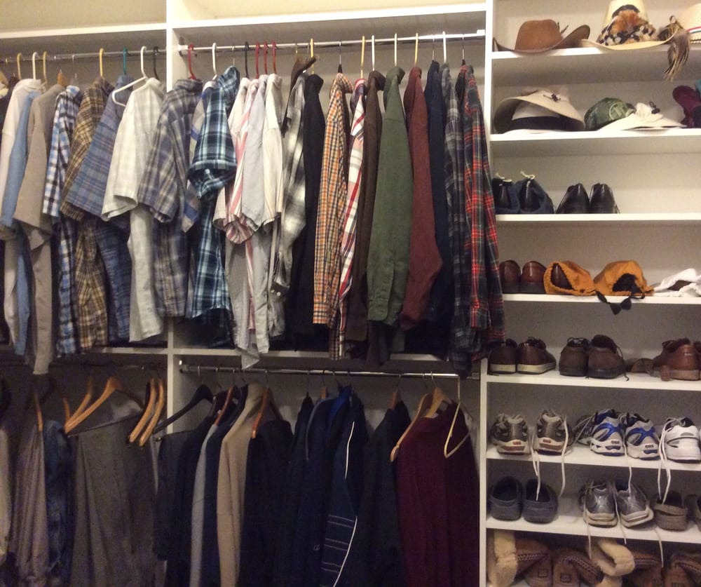 A closet filled with lots of clothes and shoes