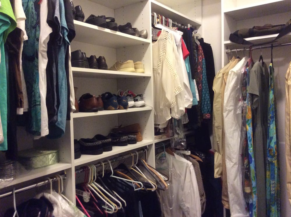A closet filled with lots of clothes and shoes