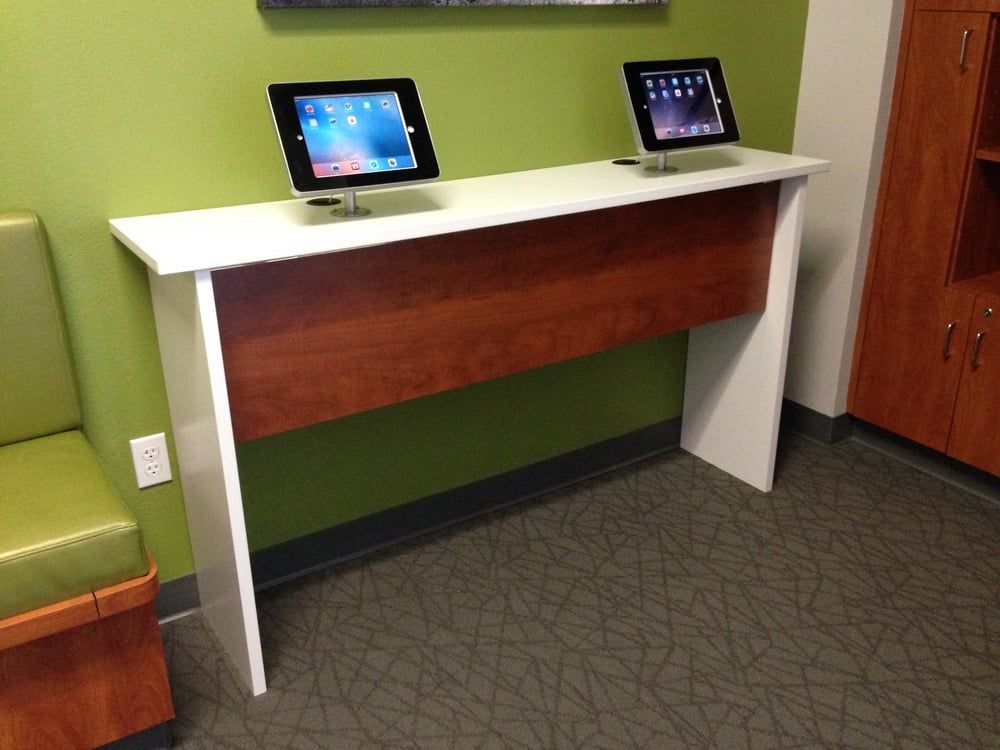 Two tablets are sitting on a table in a room