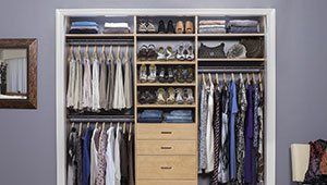 A closet filled with lots of clothes and shoes.