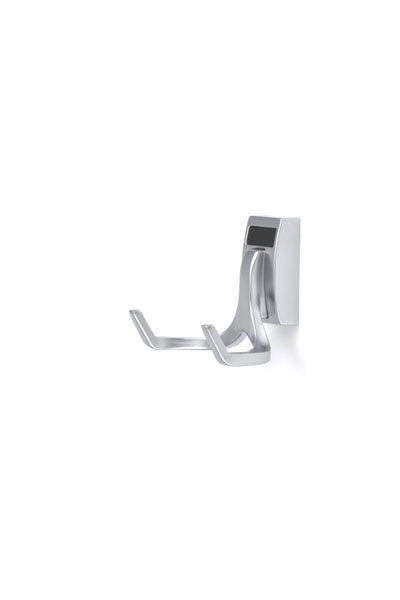 A chrome towel hook on a white wall.