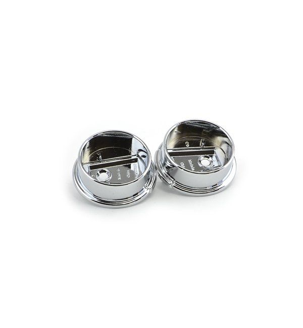 A pair of chrome cufflinks on a white background.