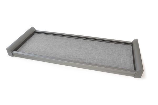 A gray tray is sitting on a white surface.