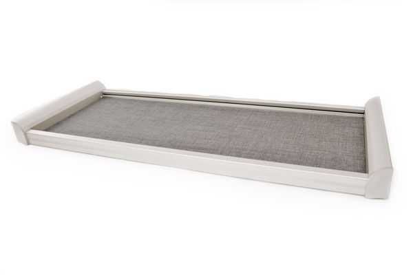 A white tray with a gray cushion on a white background.