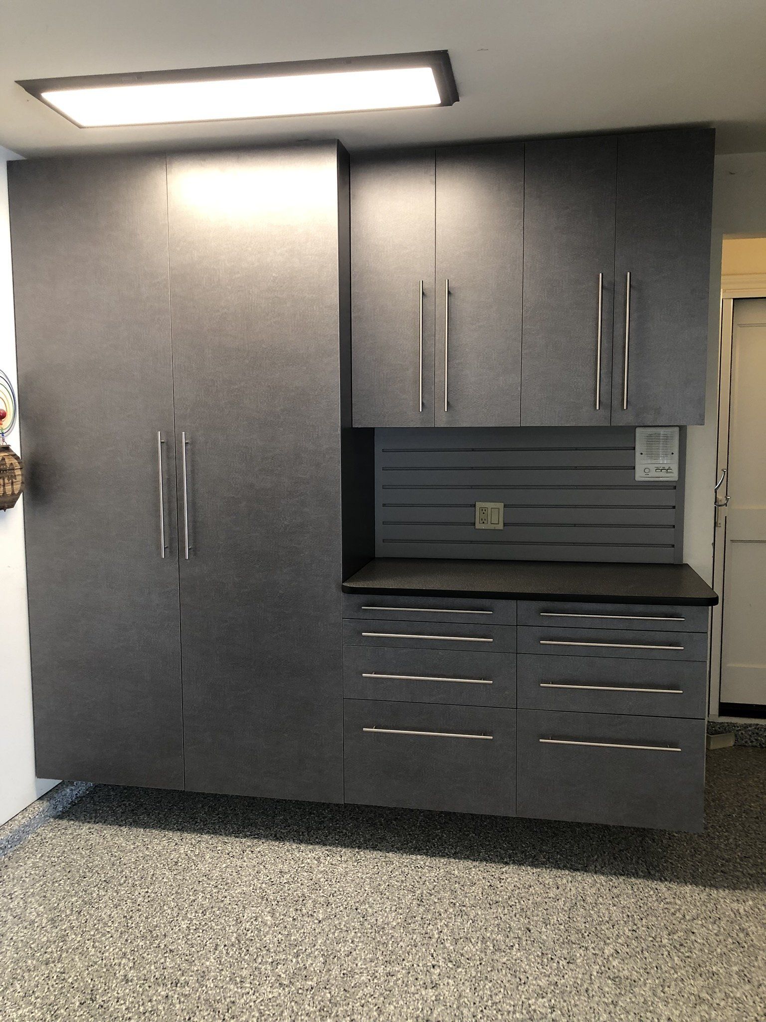 A garage with a lot of cabinets and drawers.
