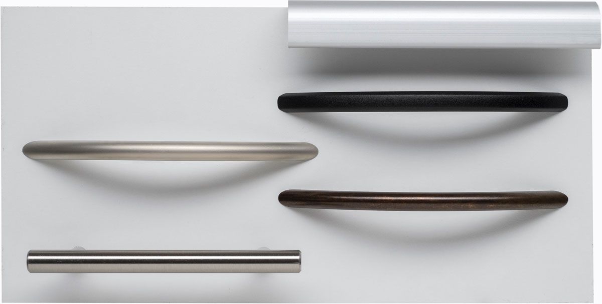 Three different types of handles are on a white surface.